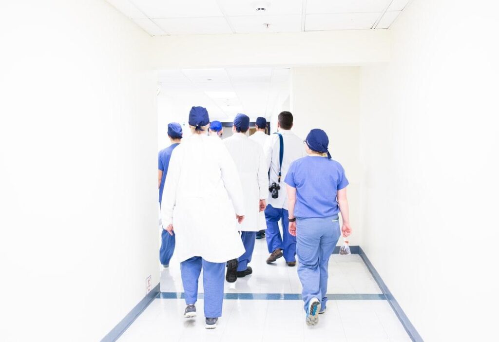 Group of clinicians walking in through a hospital corridor