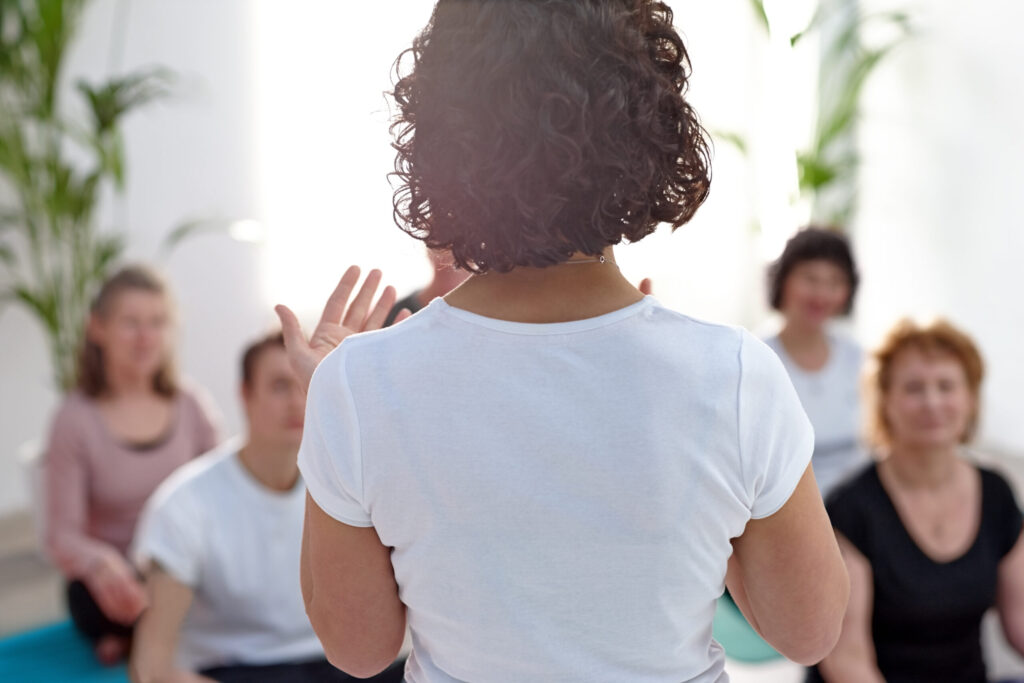 Rear view of female instructor guiding student during class