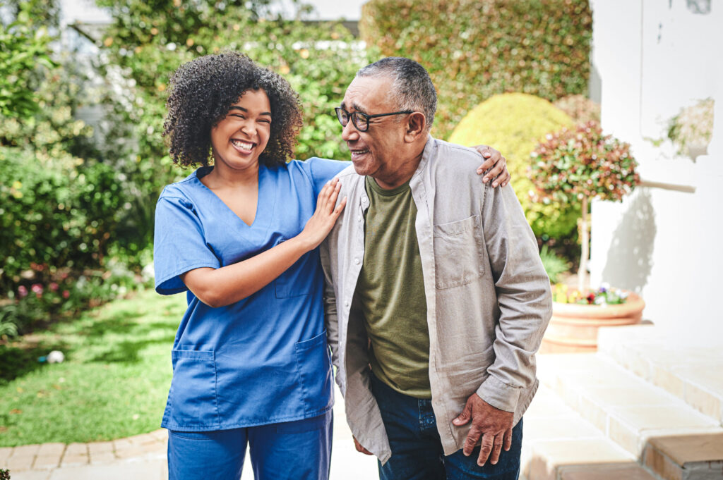 Shot of young nurse bonding with her senior patient outside