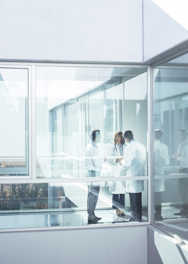 Doctors and administrator in office corridor