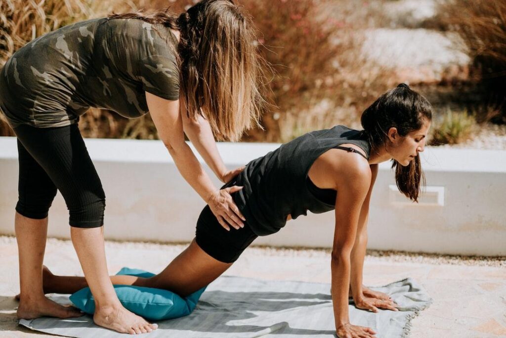 Health coach in action helping a patient stretch